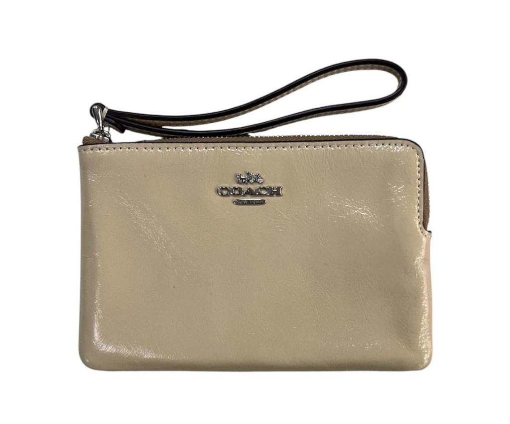 Muñequera de dama Coach color crema